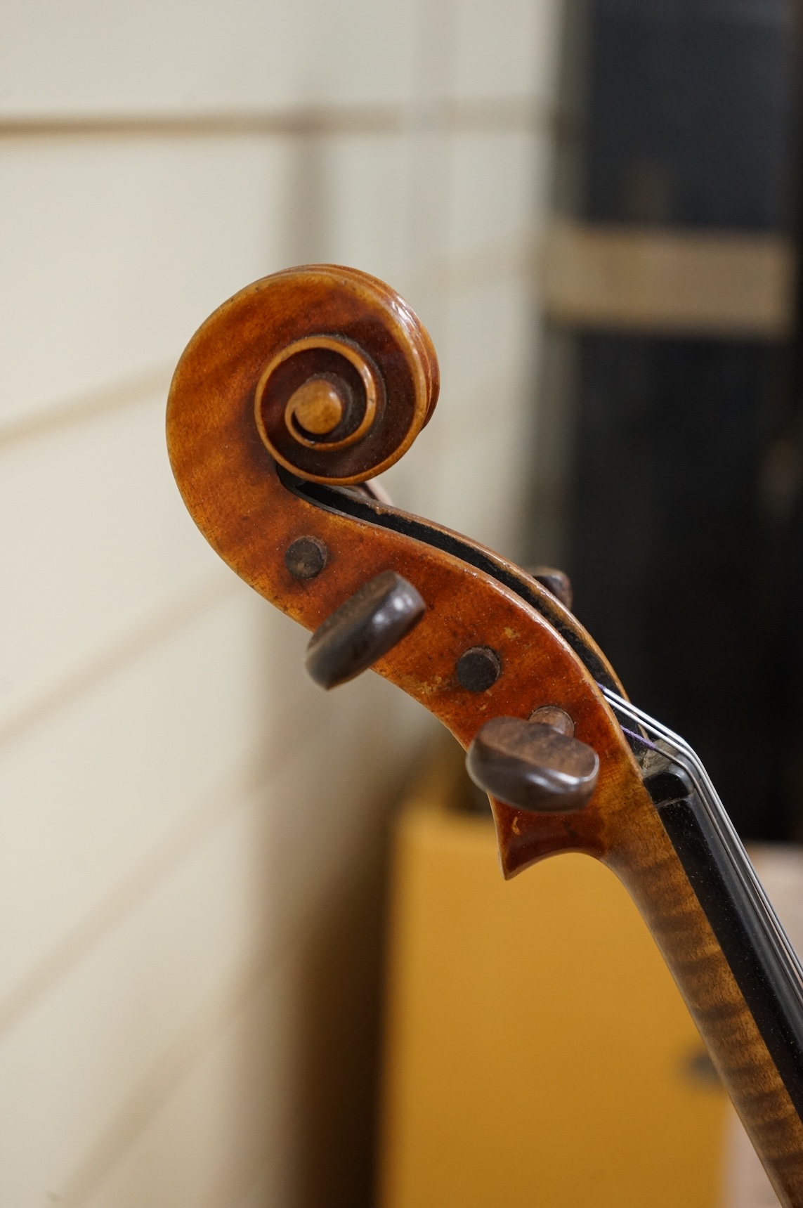 Three cased violins; a German Dresden violin, supplied by Campbell and co., Glasgow, together with another Dresden Stradivarius copy, and the remains of a European violin.